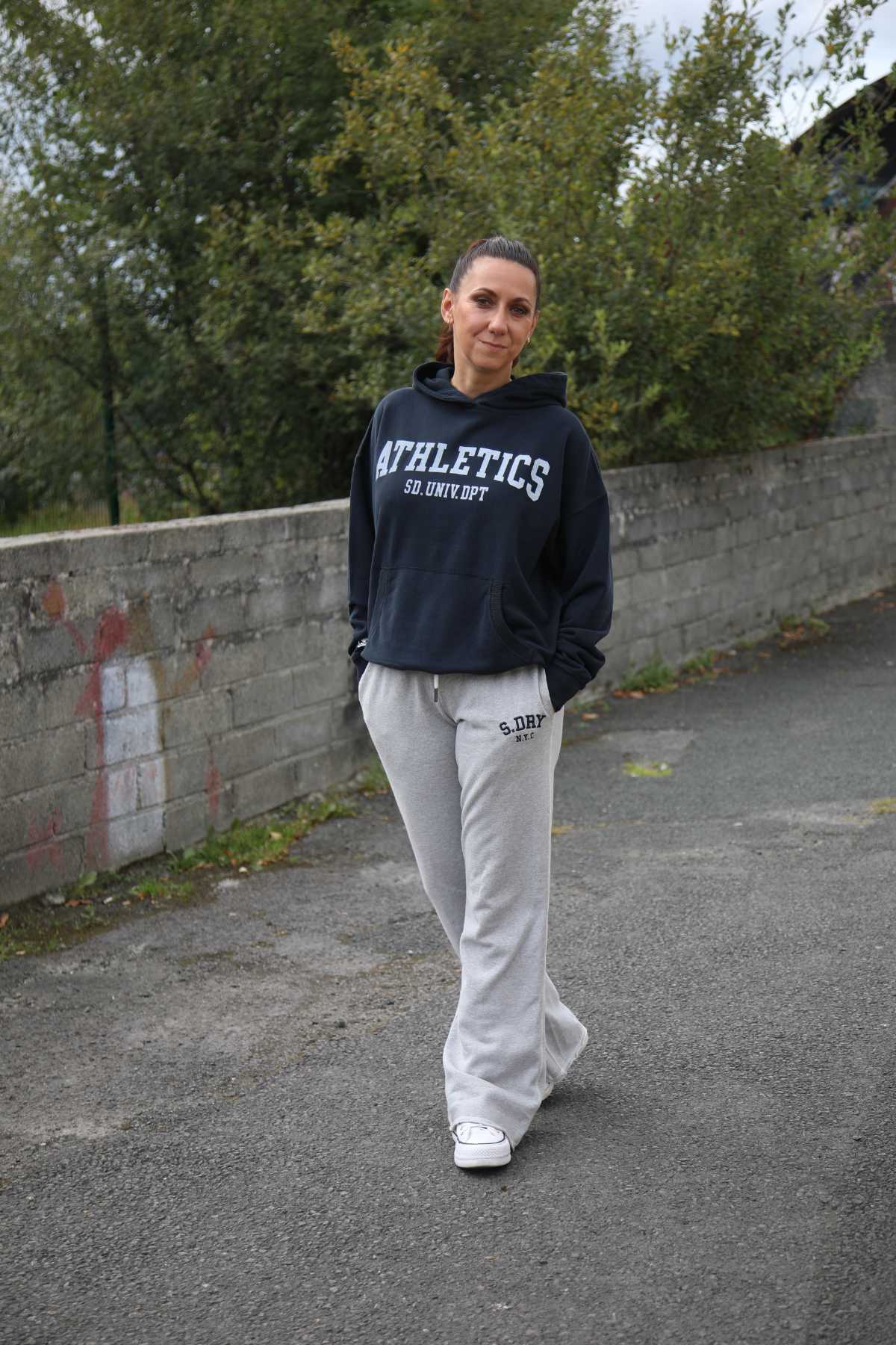 Olivia in the Athletic Essentials Navy Relaxed Hoodie paired with the Athletic Embroidered Grey Marl Flare Jogger
