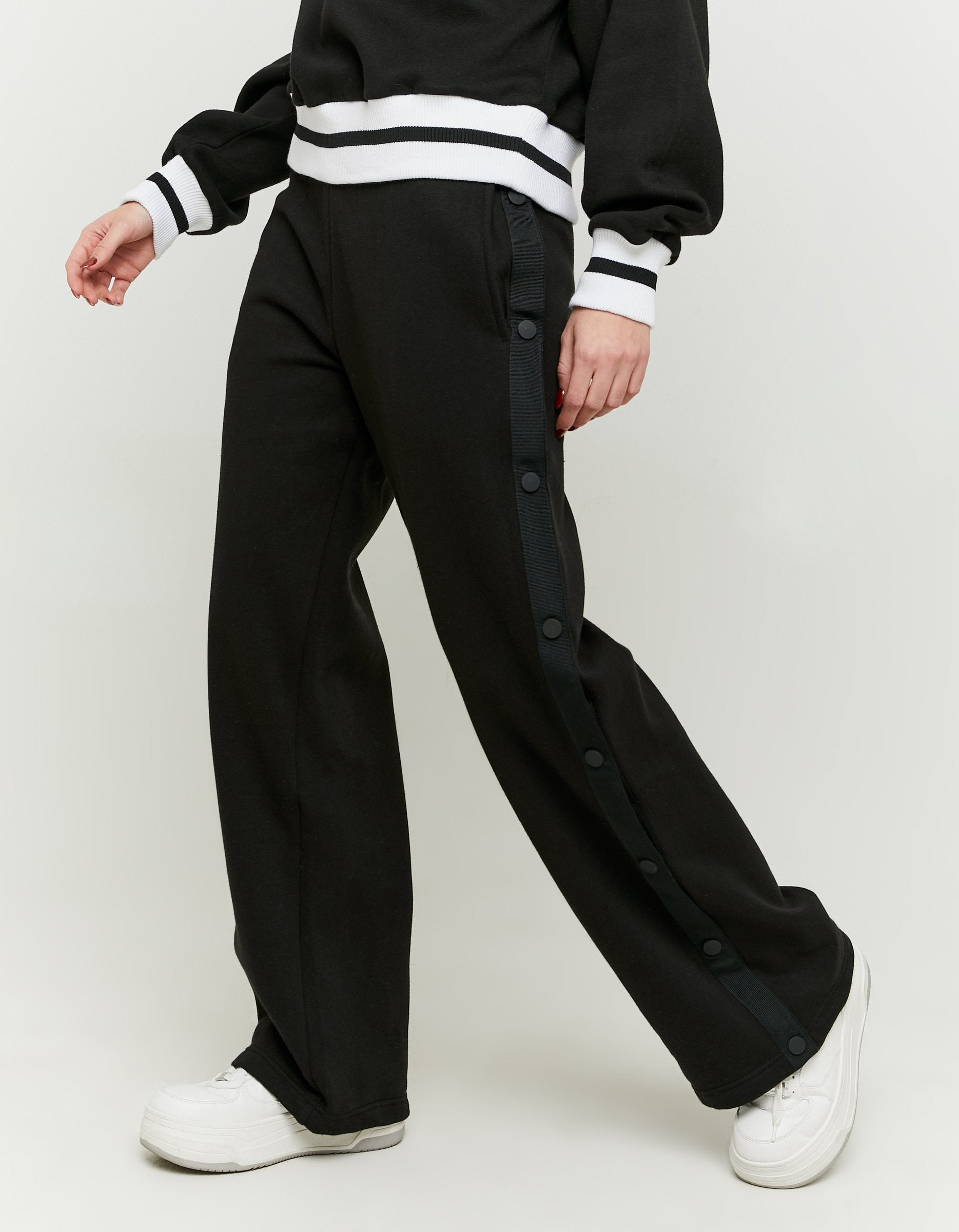 Side view of the black wide leg joggers on model