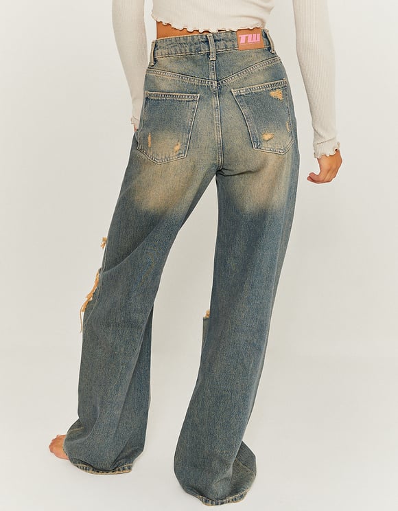 Model back view of destroyed wide leg jeans