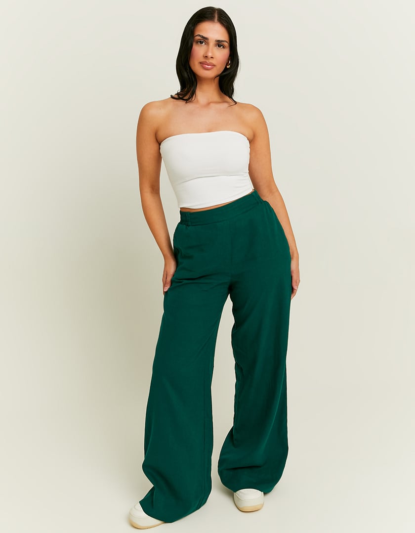 Model front view of women's green linen pants