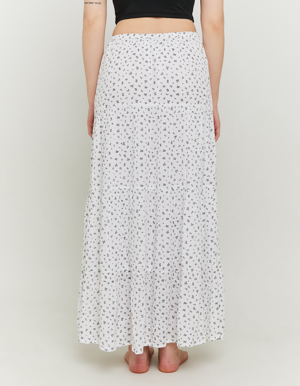 Model back view of long floral skirt