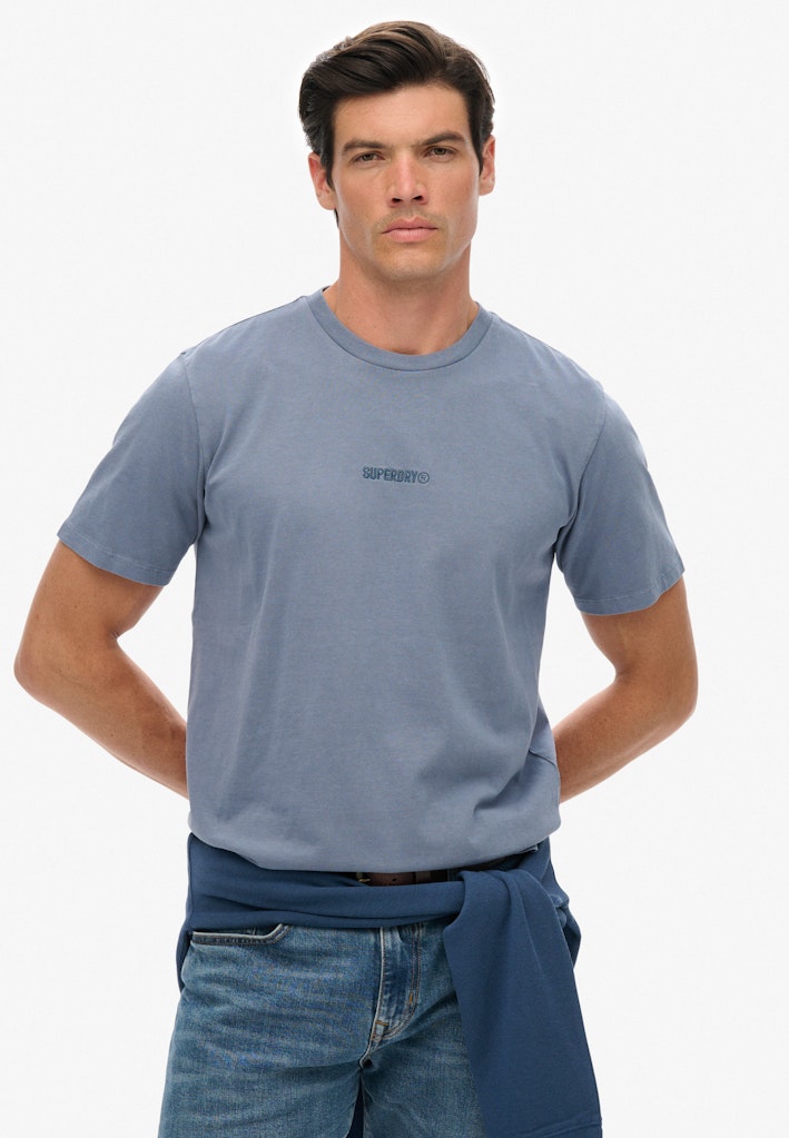 Man wearing a blue t-shirt and jeans on a white background