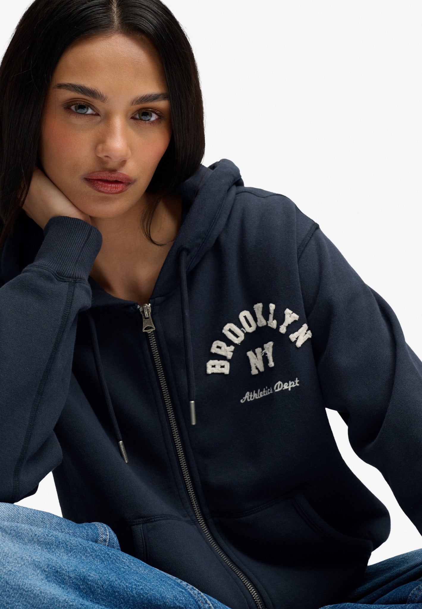 Superdry Ath Essential Relaxed Crop Ziphood in Eclipse Navy seated view
