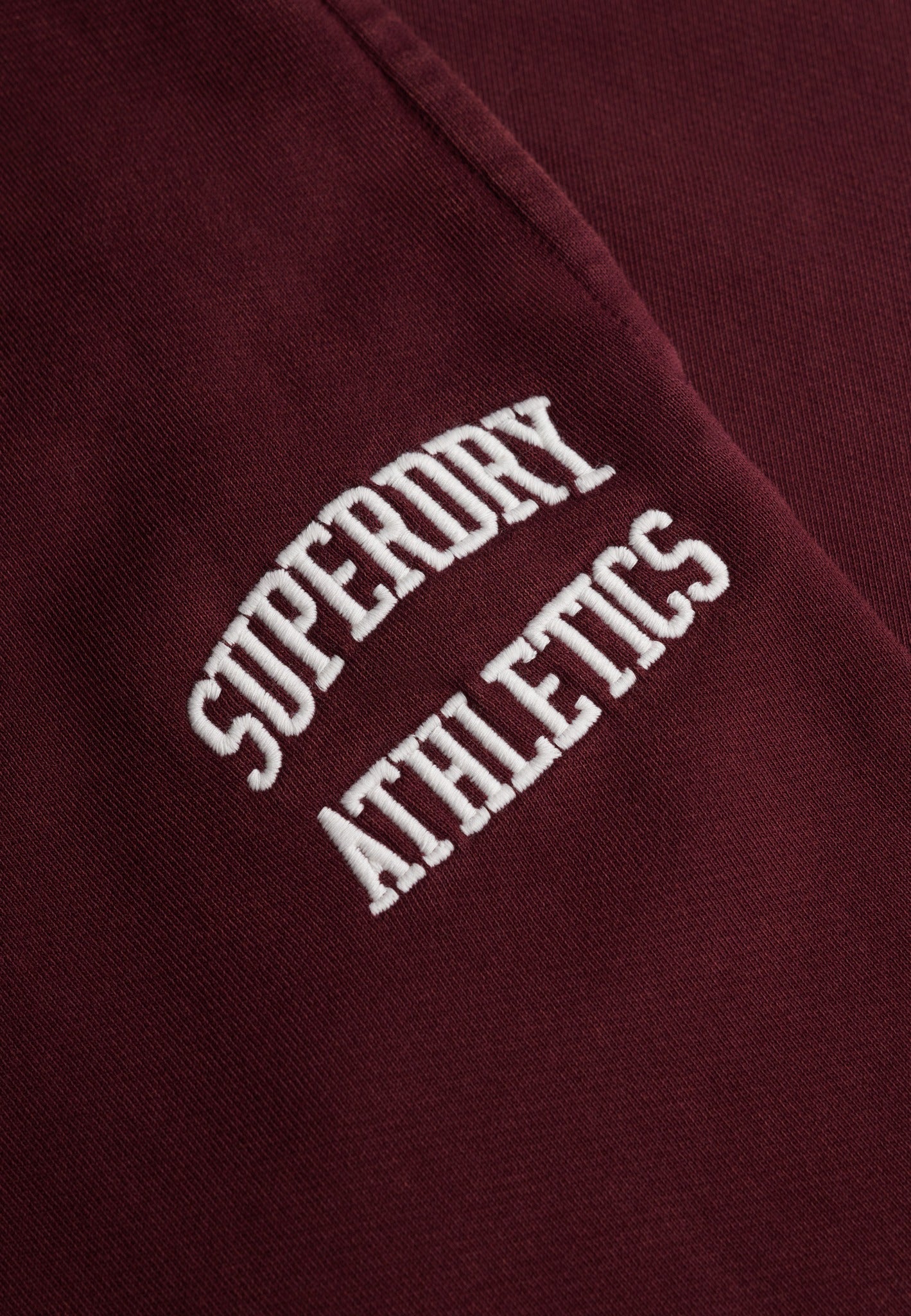 Superdry Athletic Embroidered Flare Jogger in Port Red embroidered logo detail