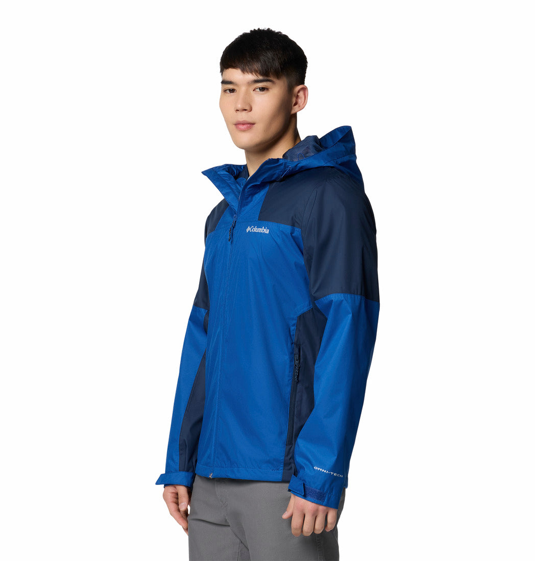 Person wearing a blue and gray Columbia jacket on a white background