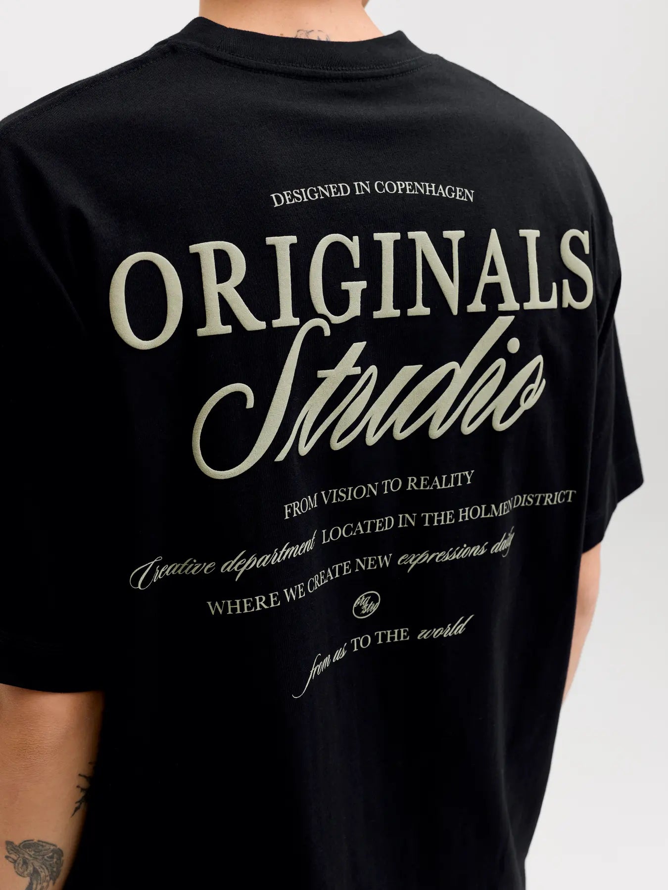 Black t-shirt with 'Originals Studio' text on a plain background