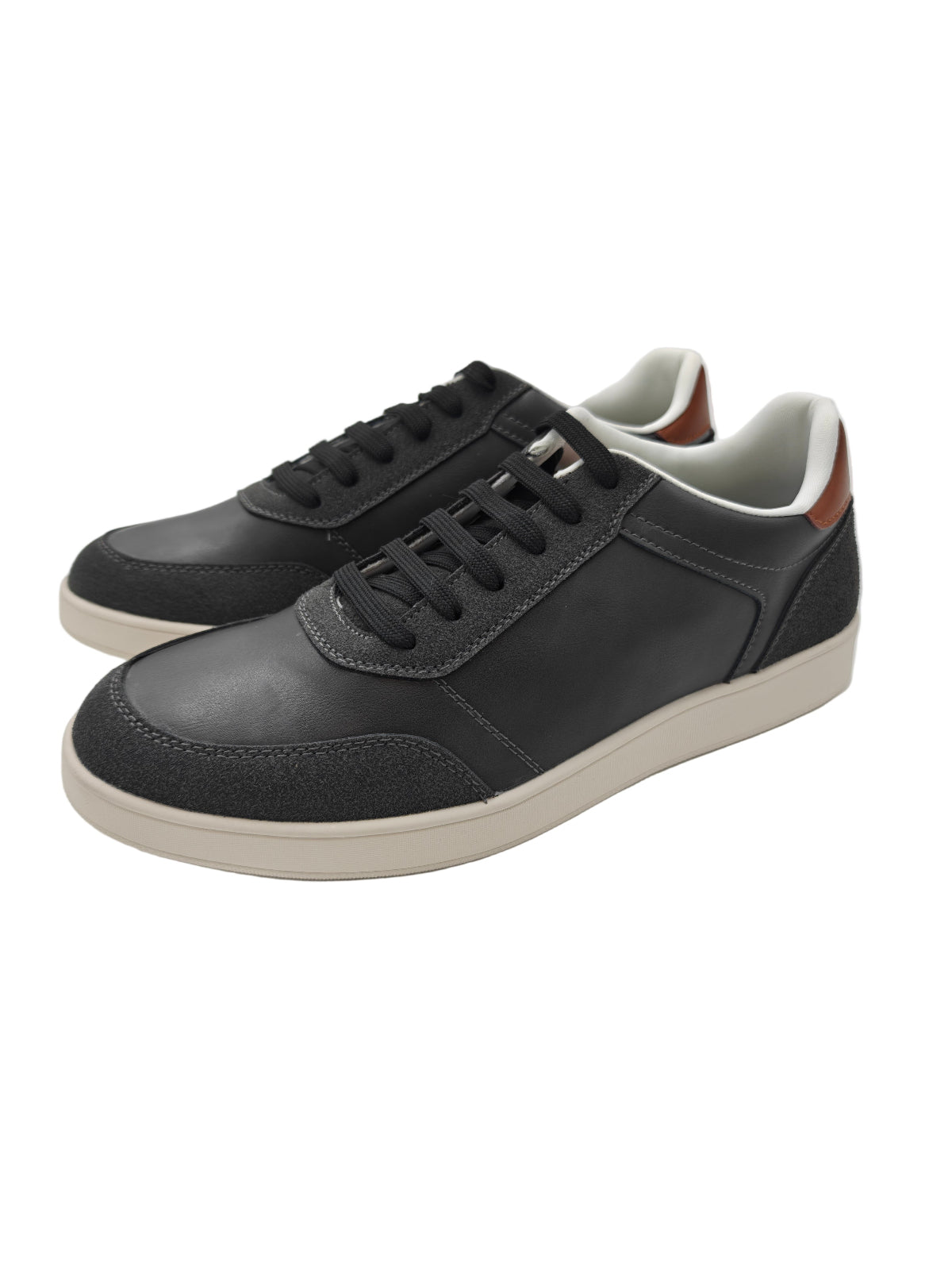 Charcoal grey sneakers with white soles on a white background