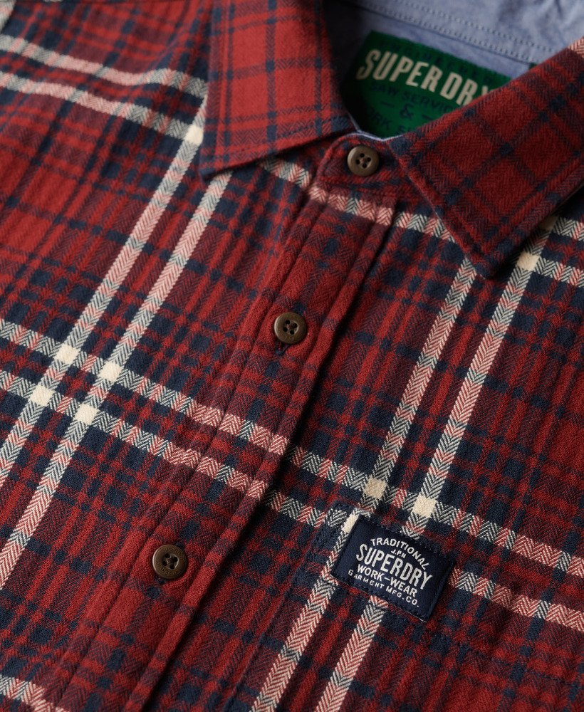 Red and blue plaid shirt with Superdry logo on a blurred background