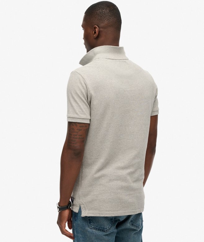 Man wearing a light gray polo shirt on a white background