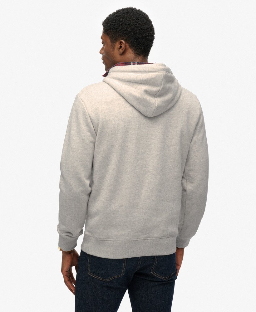 Person wearing a gray hoodie from behind on a white background