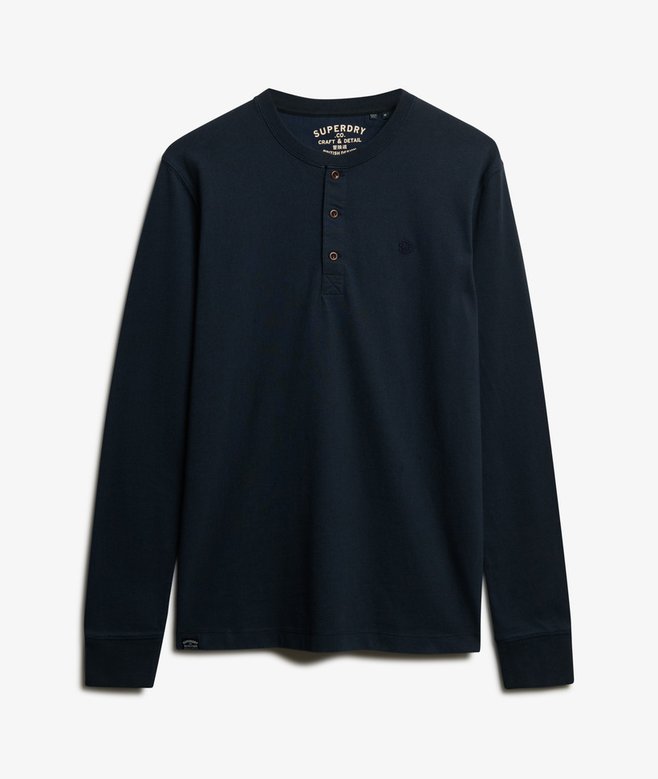 Navy long-sleeve shirt with brand logo on a light gray background