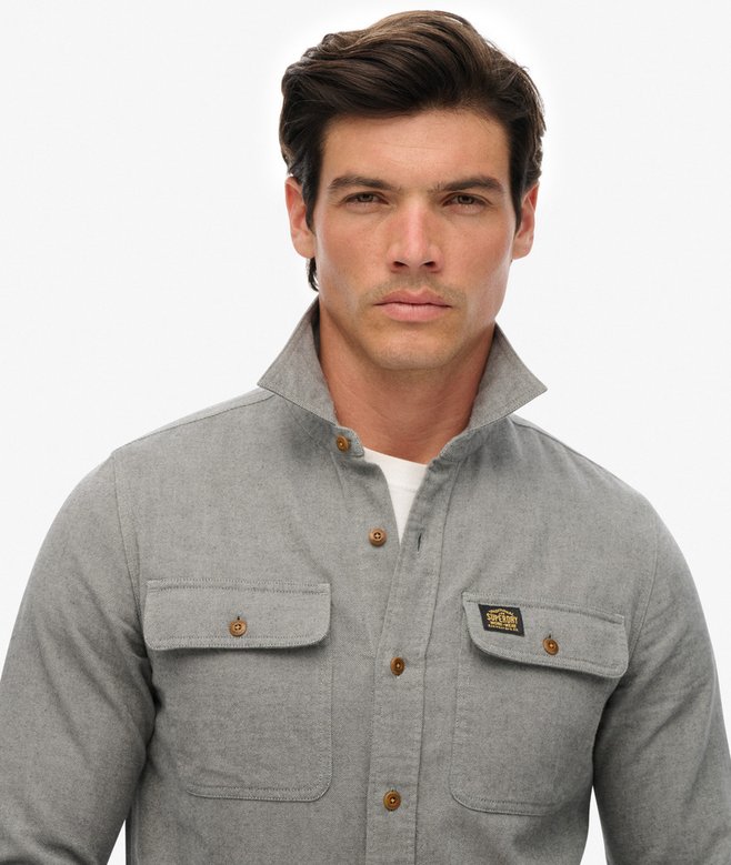 Man wearing a blue-gray shirt with a collar on a white background