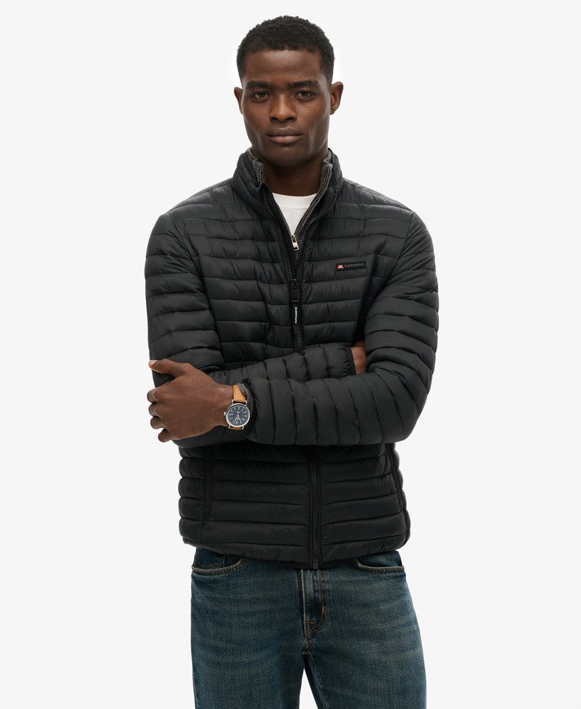 Man wearing a black puffer jacket on a white background