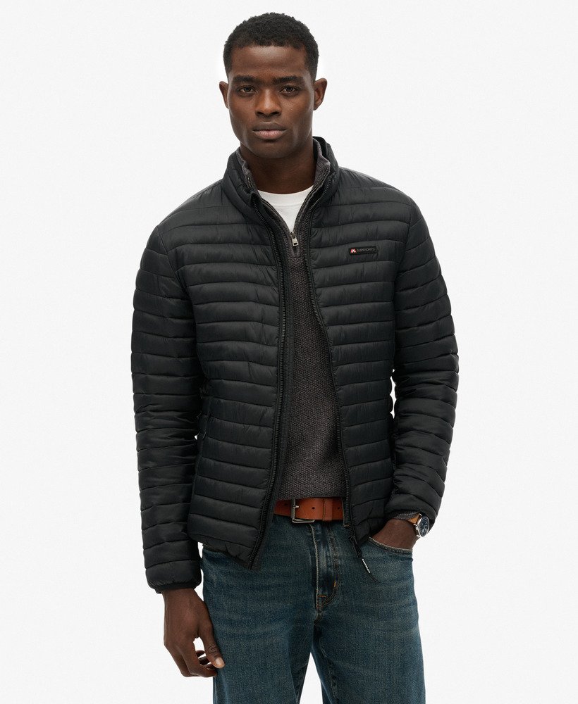 Man wearing a black quilted jacket on a white background