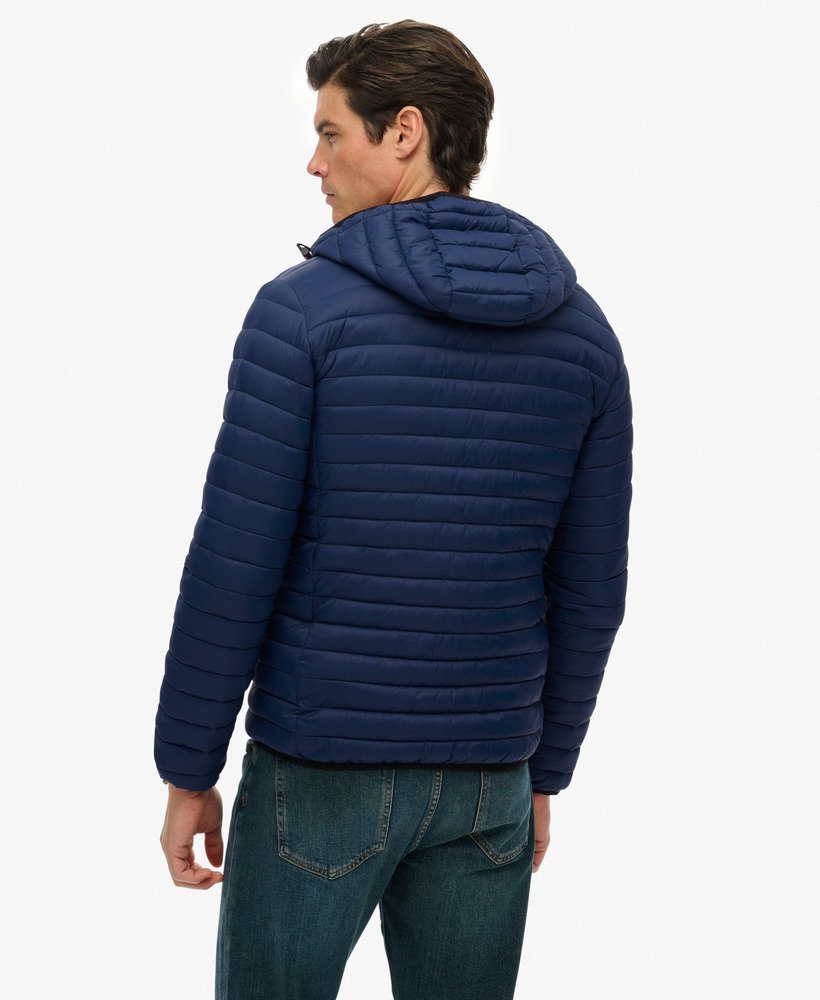 Man wearing a blue puffer jacket on a white background
