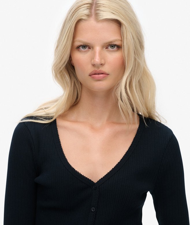Woman wearing a navy top against a white background