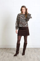 Rant & Rave Charlotte cord skirt in mocha, front model view with leopard print blouse and knee high boots.
