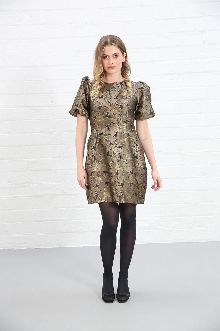 Rant & Rave Evelyn Dress in black and gold floral jacquard, front view worn by model with black tights and heels.