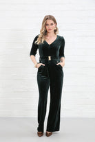 Rant & Rave Farrah Jumpsuit in green velvet, front view worn by model with hands in pockets