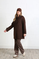 Rant & Rave Georgia Coat in chocolate brown worn by model, front view showing button front and pockets