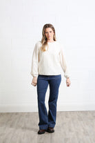 Rant & Rave Hannah top in cream, front model view with textured finish and long sleeves.