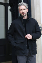 Kenrow Huxley Coat in black worn by model, front view with hands in pockets