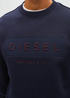 Diesel Jan Sweatshirt Metro Navy close - up front view showing embroidered Diesel logo and ribbed neckline