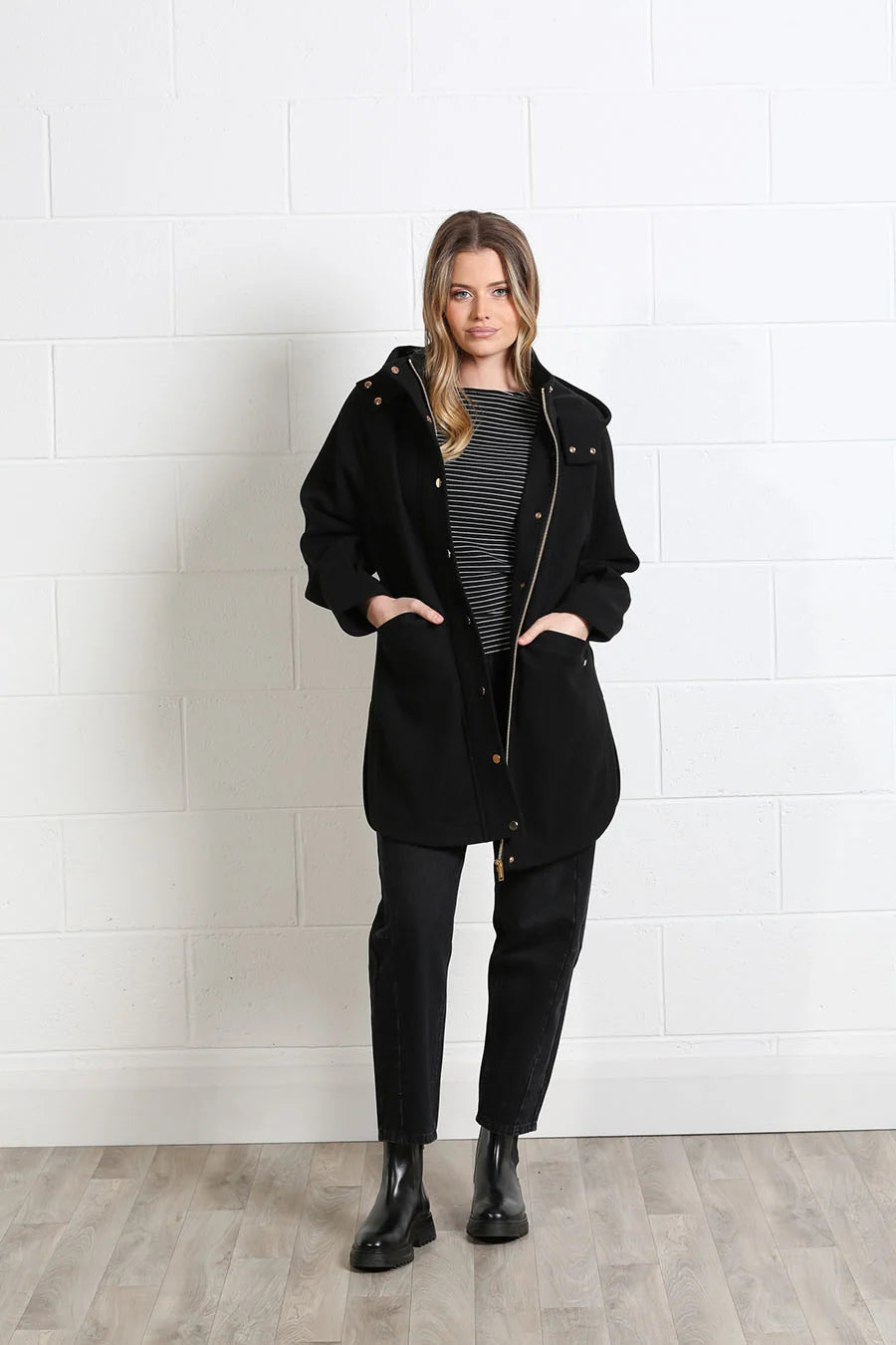 Rant & Rave Joanna Coat in black, front model view with hood and snap fastening