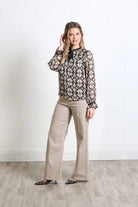 Rant & Rave Maria Top in gold, full - length front model view with long sleeves and tie neckline