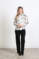 Rant & Rave Posy blouse in white, front model view with black spot print and sheer long sleeves.