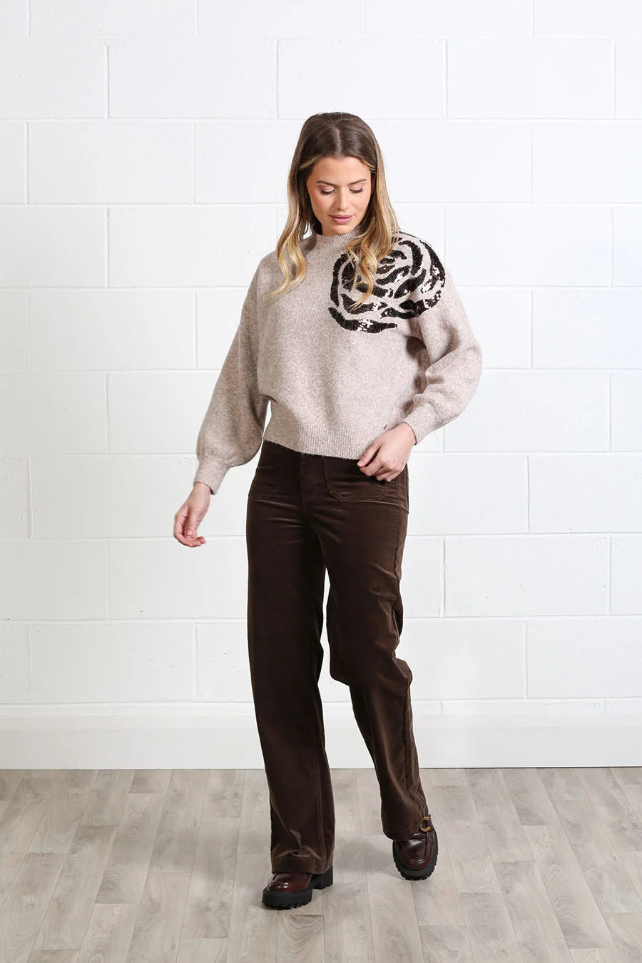 Rant & Rave Sarah Jumper in light brown worn by model, front view showing black sequin rose design on the chest