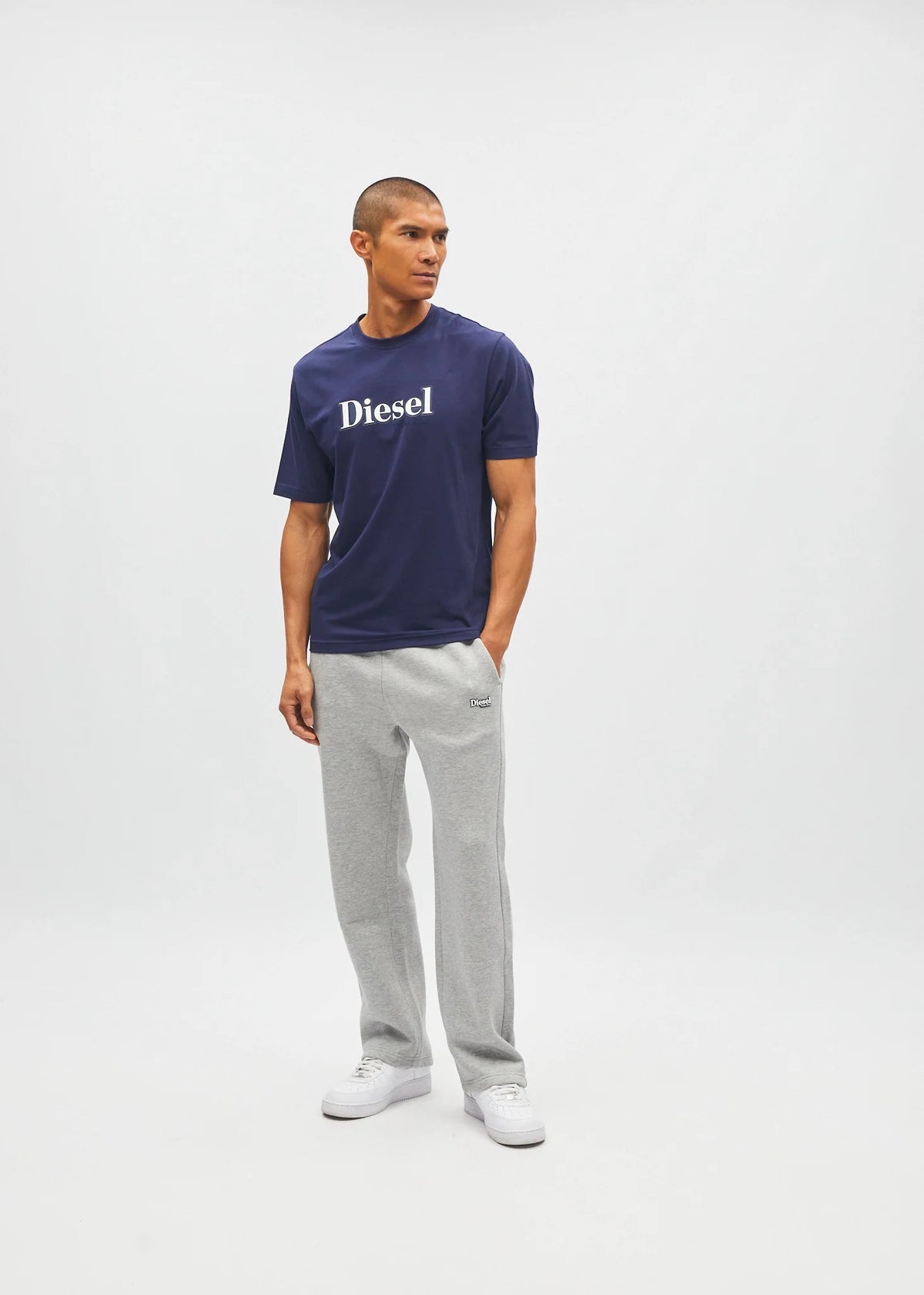 Diesel Walter Tee in navy worn by a model, angled front view with white Diesel logo across the chest.