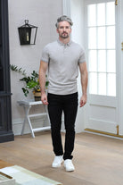 Kenrow Brett Polo in putty worn by a model with black trousers and white sneakers, full - length front view.