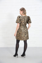 Rant & Rave Evelyn Dress in black and gold floral jacquard, back view worn by model with black tights and heels.