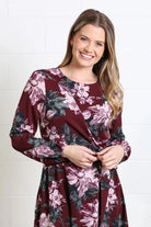 Rant & Rave Grace dress in burgundy floral, close - up model view showing wrap - effect bodice and tie waist.