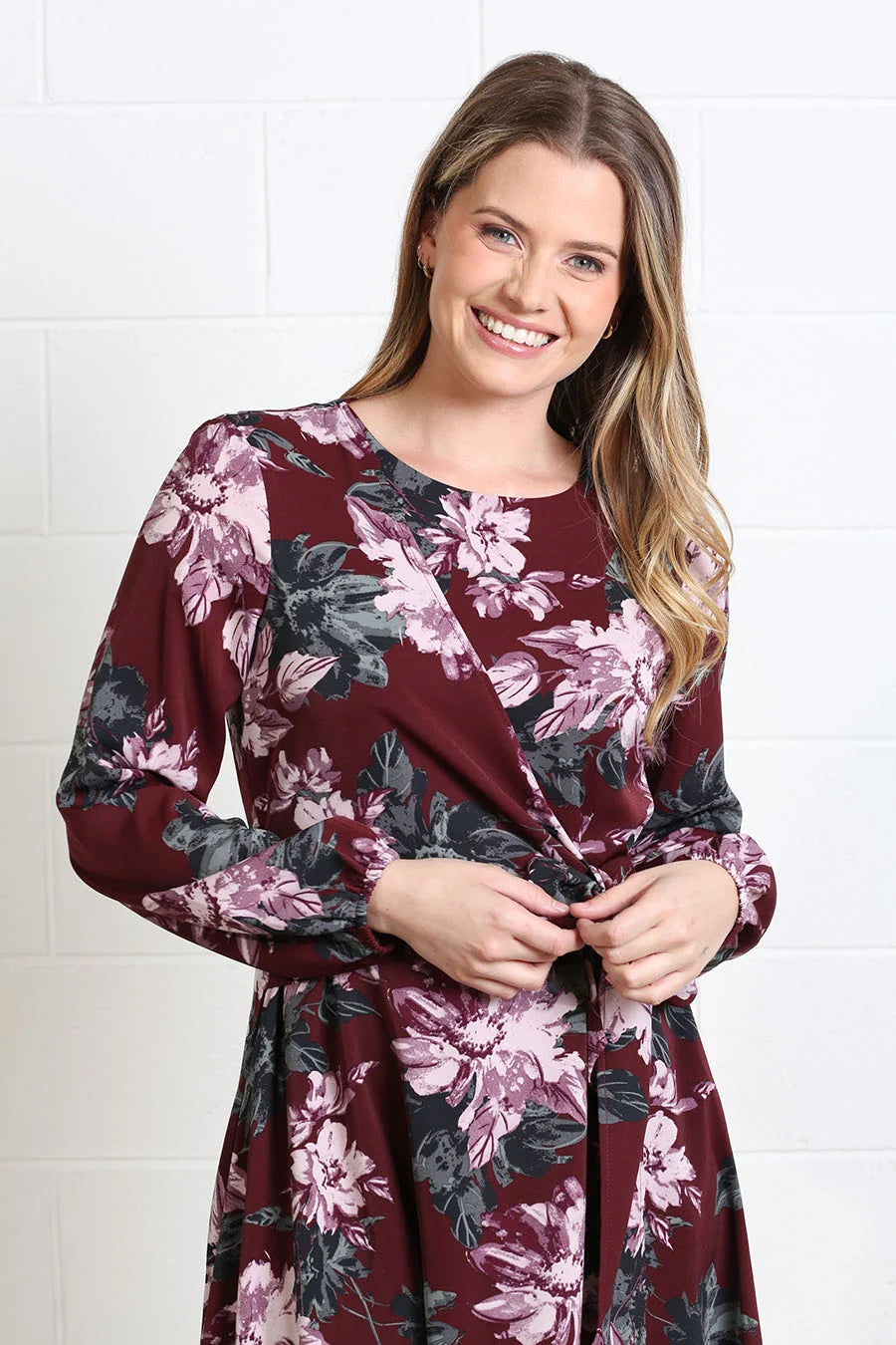 Rant & Rave Grace dress in burgundy floral, close - up model view showing wrap - effect bodice and tie waist.