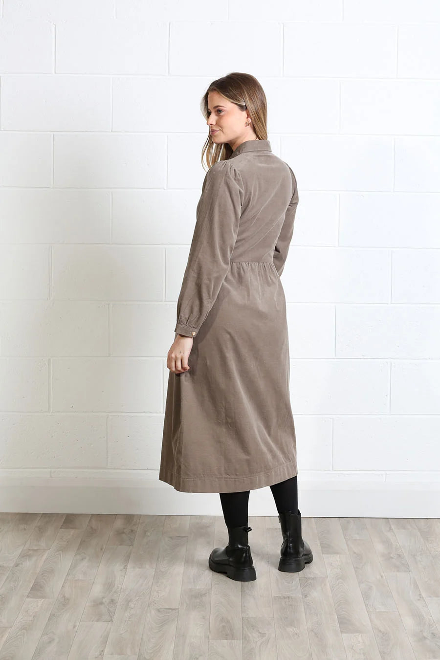 Rant & Rave Hazel Shirt Dress Biscuit in biscuit corduroy, side model view showing long sleeves and midi length.