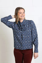 Rant & Rave Isabella Blouse in navy reef print, front model view with tie neck detail