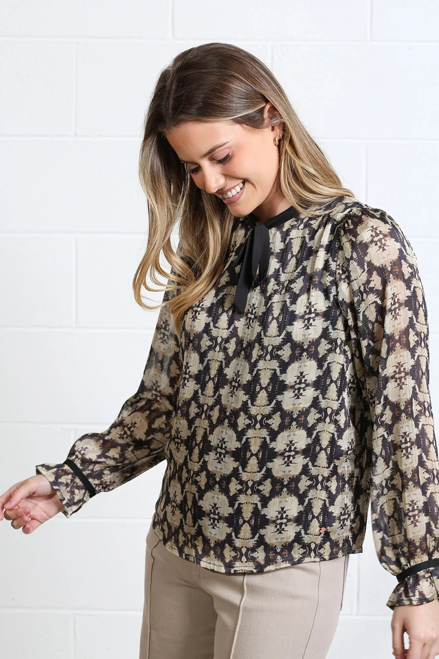 Rant & Rave Maria Top in gold, angled model view showing printed fabric and tie neckline