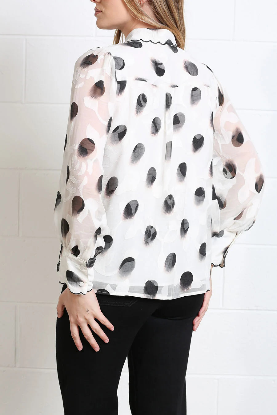 Rant & Rave Posy blouse in white, back view showing black spot print and sheer sleeves.