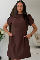 Girl In Mind ami tulip sleeve high neck mini dress in brown worn by model, front view with hands in pockets
