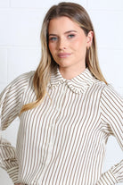 Rant & Rave Stella shirt in brown and white stripe, worn by model, collar detail view