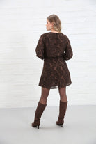 Rant & Rave Susannah Wrap Dress in brown, back view worn by model showing tie waist and long sleeves