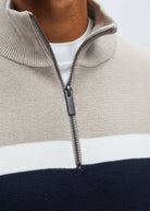Detail view of Diesel Tully Half Zip sweater showing sand collar, white stripe and zip pull.