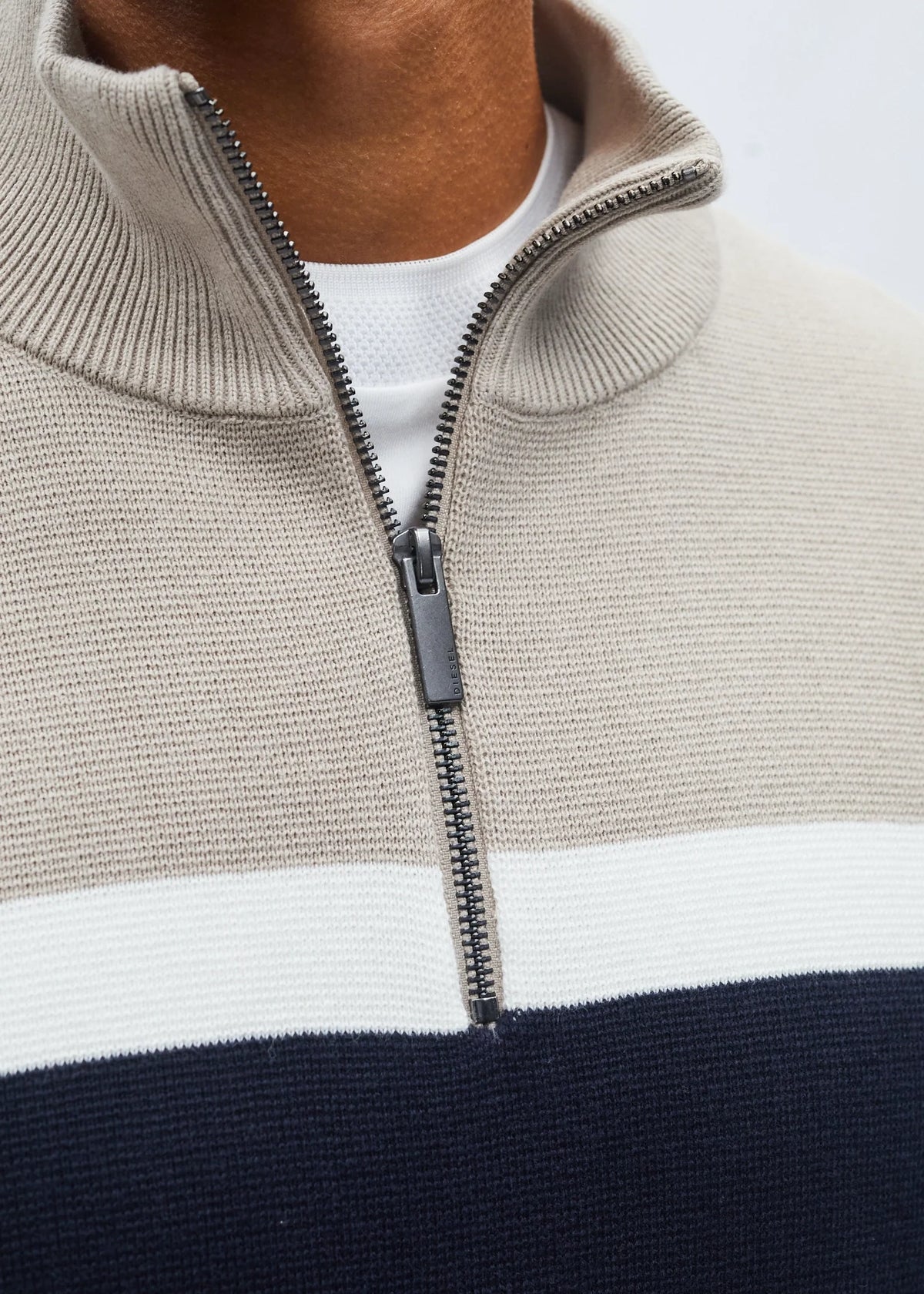 Detail view of Diesel Tully Half Zip sweater showing sand collar, white stripe and zip pull.