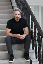 Kenrow Vinny Polo in black worn by model sitting on stairs