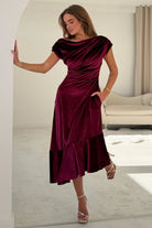 Girl In Mind Felicity asymmetric frill midi dress in berry velvet, side model view revealing draped frill detail