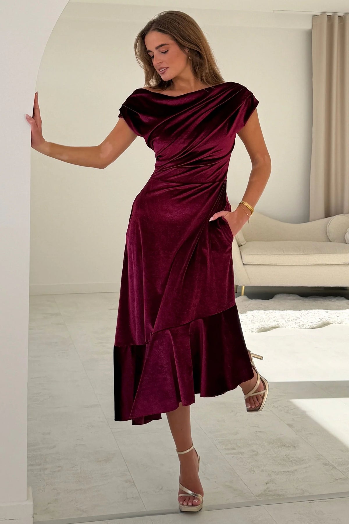 Girl In Mind Felicity asymmetric frill midi dress in berry velvet, side model view revealing draped frill detail