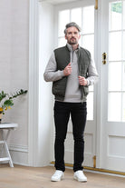 Kenrow Andy Gilet in light khaki worn by model adjusting the front zip, front model view