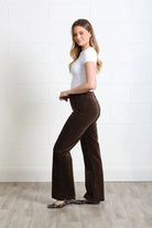 Side profile of the Rant & Rave Bridget Cord Wide Leg mocha trousers in a stretch cord fabric, worn by a model.